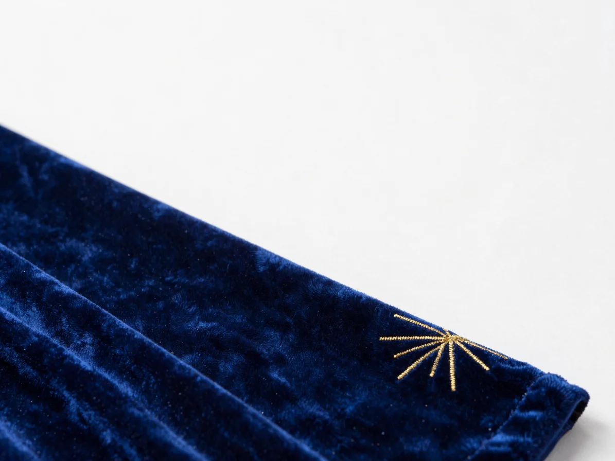 Close-up macro shot of royal velvet blue fabric with fine gold em